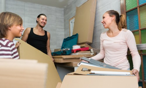 Professional furniture removals team handling a sofa in Westhampstead