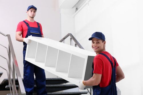 Professional flat removal team handling apartment furniture in Westhampstead