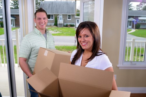 Trained movers carrying furniture with protective equipment