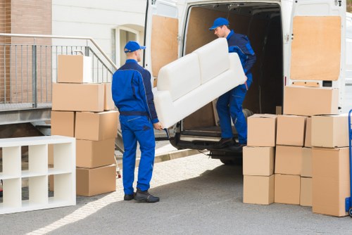 Removal staff using PPE while loading items carefully
