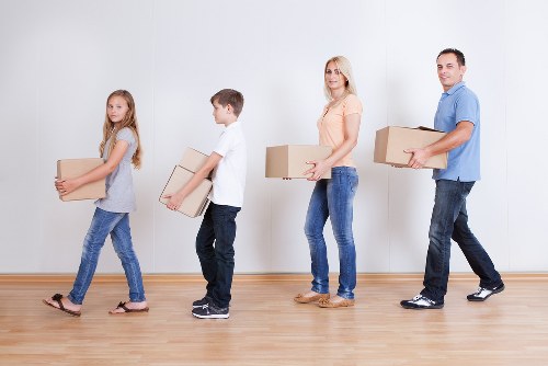 Professional movers loading boxes for an urgent move